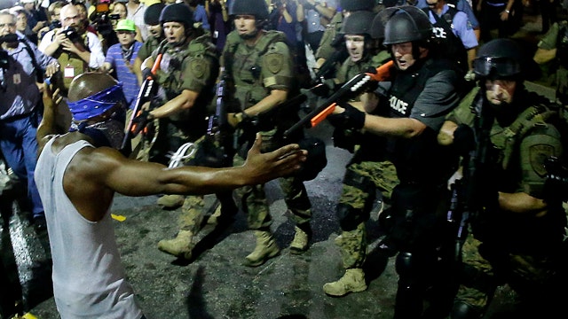Ferguson protesters defy demand to leave streets after dark