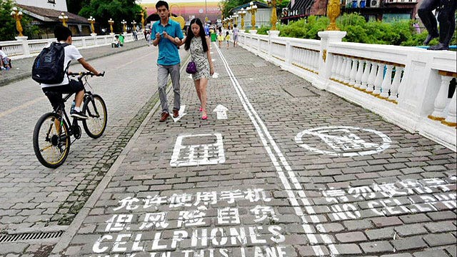 Chinese city creates sidewalk lane for people on phones