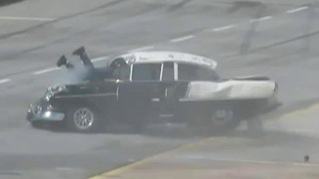 Driver hangs out windshield after dramatic drag race crash