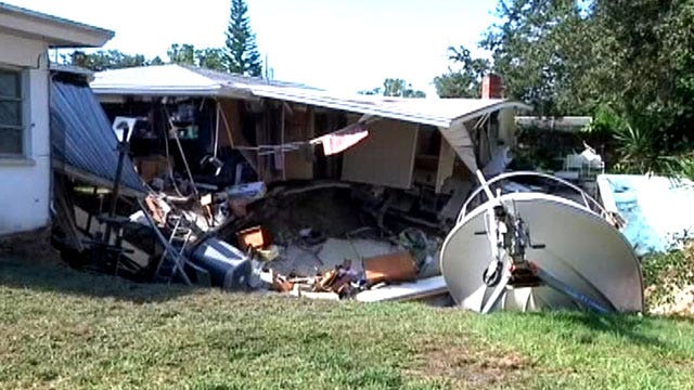 Sink hole swallows parts of 2 homes