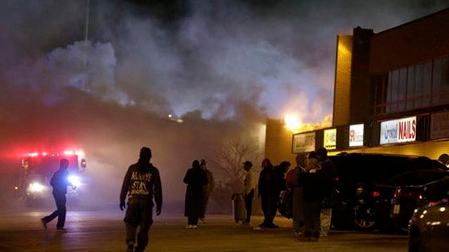 Shots fired as buildings burn in Ferguson, Missouri