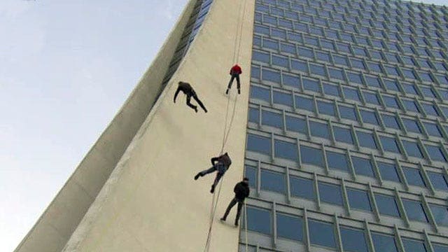 Rick Reichmuth rappels down a 22-story building