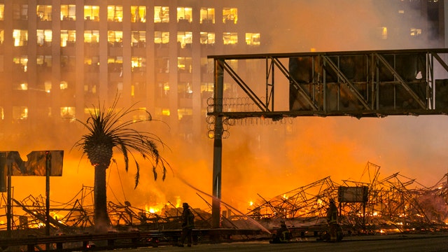 Massive apartment fire shuts down 2 major freeways in LA