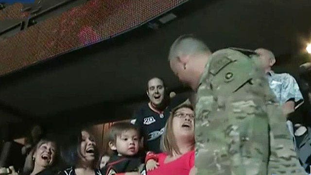 Sergeant surprises his wife on big board at hockey game