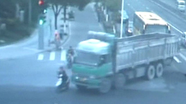 Truck runs over woman riding scooter