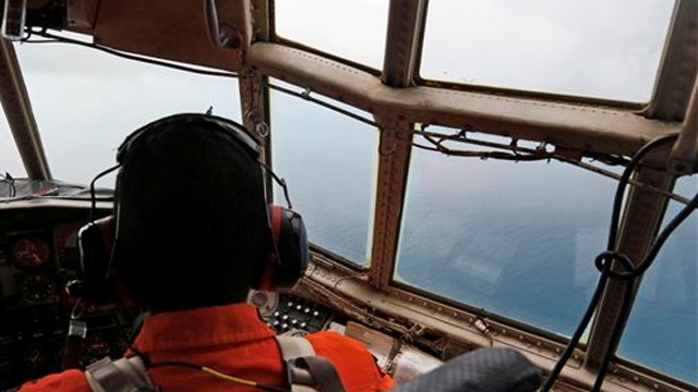 Search for AirAsia flight on hold as crew test oil slick