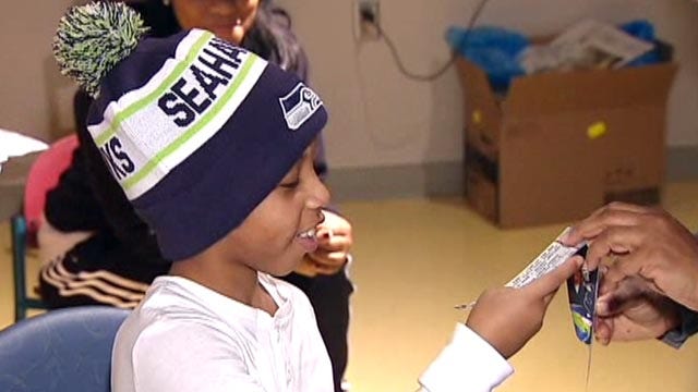 Officer surprises 9 year-old shooting victim with WWE gift