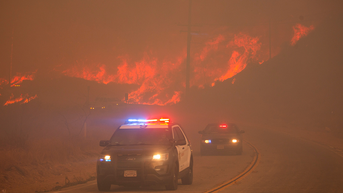 2 cop cars in front of fire - Fox News