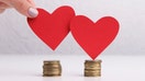 Budget planning. Creative red hearts and money savings for wedding concept on background