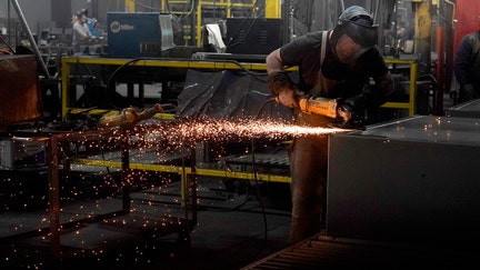 PAYSON, UT - MARCH 22: A worker grinds a weld on a safe that is being manufactured at Liberty Safe Company on March 22, 2022 in Payson, Utah. Liberty Safe has struggled with supply constraints and price increases in their materials used in manufacturing of their safes.  (Photo by George Frey/Getty Images)