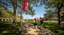 Students walk around the campus at Stony Brook University in Stony Brook, New York on Aug. 26, 2021. (Photo by J. Conrad Williams Jr./Newsday RM via Getty Images)