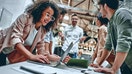 A group of young professionals work together in an office.