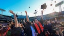 Boston, MA - May 7: Northeastern University students celebrate the conclusion of their Universitys 121st undergraduate commencement at Fenway Park by throwing their caps in the air. (Photo by Matthew J. Lee/The Boston Globe via Getty Images)