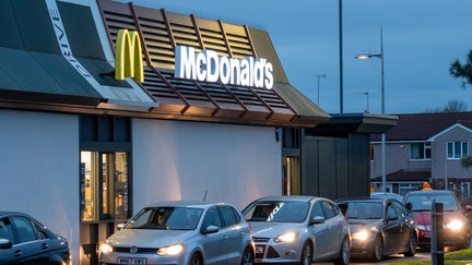 Cars queue to collect their food from the drive thru at the fast food restaurant McDonald's, on November 18, 2023 in Bristol, England. Founded in 1940, American multinational fast food chain McDonald's Corporation, best known for its Big Mac hamburgers, cheeseburgers and french fries, is the world's largest fast food restaurant chain.  (Photo by Matt Cardy/Getty Images)