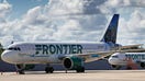 Frontier Airlines planes are seen parked at Orlando International Airport in April 2020. 