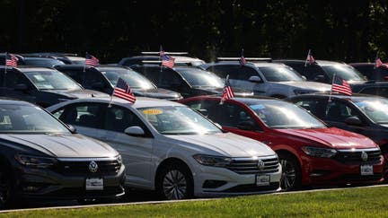 Vehicles for sale on a Volkswagen dealership lot in St. James, New York on Sept. 21, 2022.