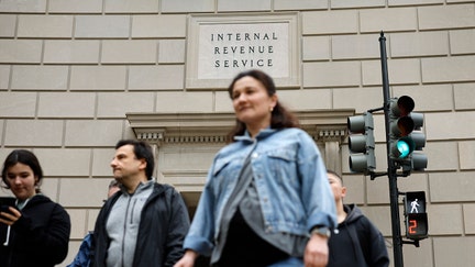 Tourists walk past the headquarters of the Internal Revenue Service near the National Mall on April 07, 2023 in Washington, DC.