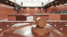 A judge&apos;s gavel inside a court room.