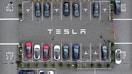 FREMONT, CALIFORNIA - APRIL 24: In an aerial view, brand new Tesla cars sit parked in a lot at the Tesla Fremont Factory on April 24, 2024 in Fremont, California. Electric car maker Tesla announced plans to lay off nearly 3,000 workers at facilities in the San Francisco Bay Area in June. The company plans to lay off 10 percent of its 140,000 thousand employees worldwide. 