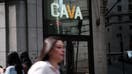 NEW YORK, NEW YORK - JUNE 15: People walk by the Mediterranean restaurant chain Cava is displayed as the company goes public on the New York Stock Exchange (NYSE) on June 15, 2023 in New York City. Cava priced its IPO at $22 per share, valuing the company at $2.5 billion. (Photo by Spencer Platt/Getty Images)
