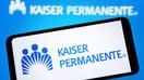 UKRAINE - 2023/10/14: In this photo illustration, Kaiser Permanente logo is seen on a smartphone and on a pc screen. (Photo Illustration by Pavlo Gonchar/SOPA Images/LightRocket via Getty Images)
