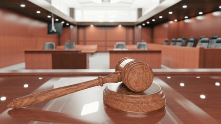 A judge's gavel inside a court room.