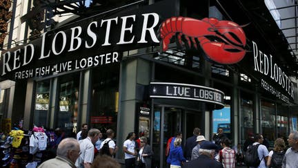 Pedestrians pass in front of a Red Lobster restaurant in New York, U.S., on Wednesday, Sept. 19, 2012.