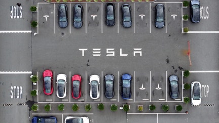FREMONT, CALIFORNIA - APRIL 24: In an aerial view, brand new Tesla cars sit parked in a lot at the Tesla Fremont Factory on April 24, 2024 in Fremont, California. Electric car maker Tesla announced plans to lay off nearly 3,000 workers at facilities in the San Francisco Bay Area in June. The company plans to lay off 10 percent of its 140,000 thousand employees worldwide. 