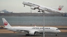 A passenger jet from Japanese carrier Japan Airlines (JAL) takes off past another at Tokyo International Airport at Haneda on February 2, 2023.