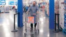 Sam&apos;s Club customer leaving store through new artificial intelligence-powered exit checkpoint.
