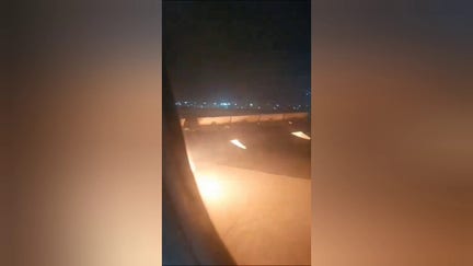 A passenger recorded video of the fire intensifying as they waited inside the plane on the tarmac.