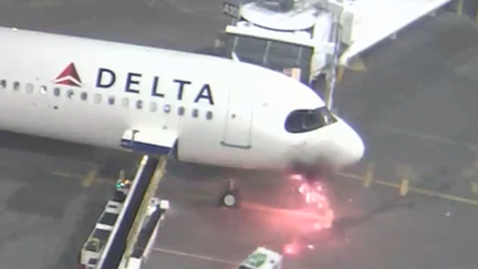 Sparks and a fire are seen developing on a Delta Airbus jet that landed in Seattle on Monday, May 6.