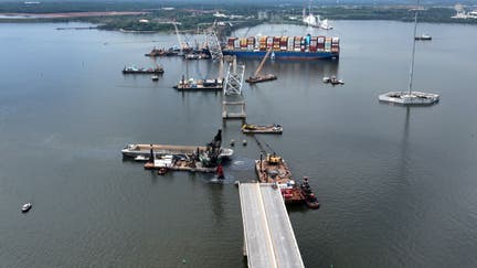 In this aerial view, salvage crews continue to remove wreckage from the Dali six weeks after the cargo ship collided with the Francis Scott Key Bridge May 08, 2024 in Baltimore, Maryland. Officials announced this week that precision explosive charges will be used to separate the Dali from the spans of the bridge that collapsed over its bow which should make it possible to move the ship and open a 45-foot channel in the Patapsco River. Salvage teams on Tuesday found remains of construction worker Jose Minor Lopez, the final missing victim of the March 26 collapse. 