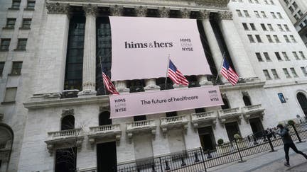 The New York Stock Exchange with a Hims & Hers Health, Inc banner is pictured as a person runs past in the Manhattan borough of New York City, New York, U.S., January 21, 2021. 