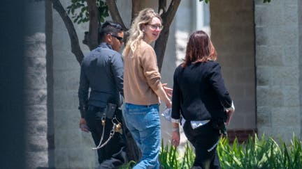 Elizabeth Holmes, founder of Theranos Inc., center, arrives at Federal Prison Camp Bryan in Bryan, Texas, US, on Tuesday, May 30, 2023. Holmes surrendered to authorities on Tuesday to begin her 11 1/4-year sentence after she was convicted by a jury last year of defrauding investors in the blood-testing startup.