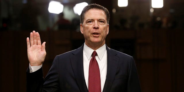 Former FBI Director James Comey being sworn in during a Senate testimony.