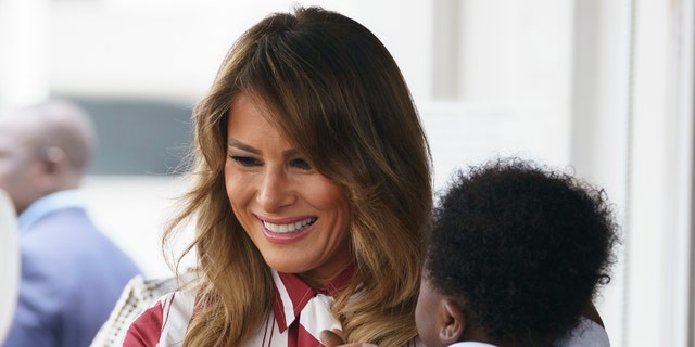 First Lady Melania Trump holds a baby at the Accra Regional Hospital in Accra, Ghana. 