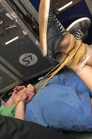 'Hooligan' on flight gets hog-tied