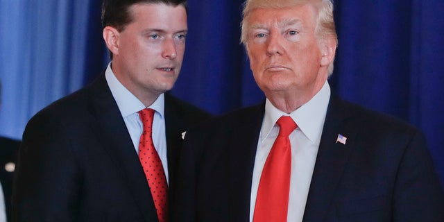 In this Aug. 12, 2017, photo, Rob Porter, left, White House staff secretary, speaks to President Trump after Trump made remarks regarding the ongoing situation in Charlottesville, Va., at Trump National Golf Club in Bedminister, N.J. (AP Photo/Pablo Martinez Monsivais)<br>