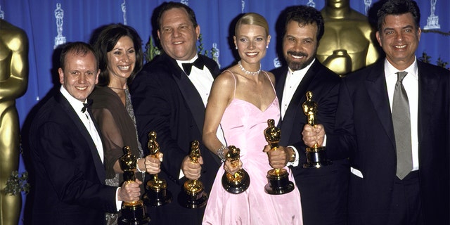 Miramax Films executive Harvey Weinstein (3rd L) and actress Gwyneth Paltrow (3R) w. producers of Shakespeare in Love holding their Oscars in Press Room at Academy Awards.