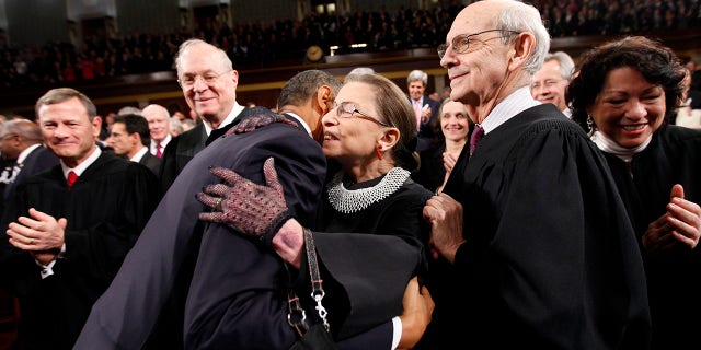 Then-President Barack Obama hugs Supreme Court Justice Ruth Bader Ginsburg on Capitol Hill in Washington, prior to his State of the Union address, Jan. 25, 2011. From left are Chief Justice John Roberts, Justice Anthony Kennedy, Obama, Justice Ginsburg and Justice Stephen Breyer. (Associated Press)