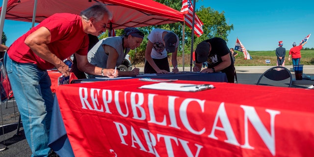 People register to vote during a Republican voter registration in Brownsville, Pennsylvania on September 5, 2020.