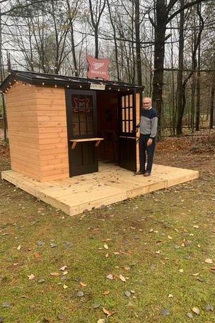 Man wins dive bar in his BACKYARD