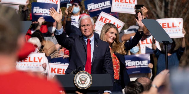 Vice President Mike Pence and Sen. Kelly Loeffler wave to the crowd during a Defend the Majority Rally, Friday, Nov. 20, 2020 in Canton, Ga. (Associated Press)