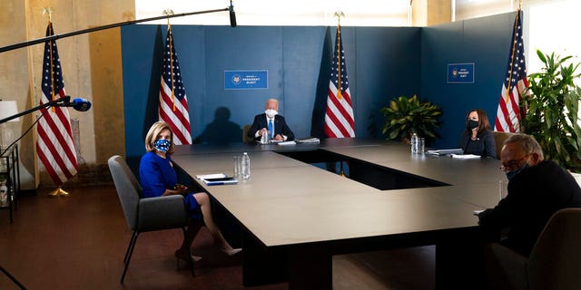 President-elect Joe Biden, speaks during a meeting with Vice President-elect Kamala Harris, right, Senate Minority Leader Chuck Schumer of N.Y., and House Speaker Nancy Pelosi of Calif., left, Friday, Nov. 20, 2020, in Wilmington, Del. (AP Photo/Alex Brandon)