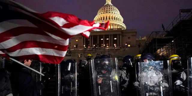 Police stand guard after a day of riots at the U.S. Capitol in Washington on Wednesday, Jan. 6, 2021. (Associated Press)