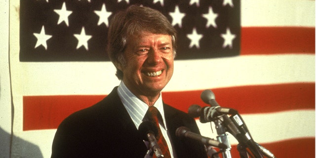 On this day in history, Jan. 21, 1977, President Carter pardons Vietnam War draft dodgers read full article at worldnews365.me 6 President Jimmy Carter is shown smiling at a podium in front of an American flag in the 1970s.