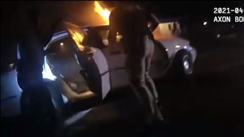 Georgia police save unconscious woman trapped in burning car, video shows
