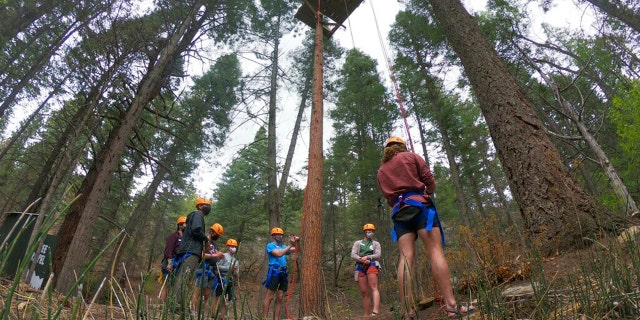 Prior to the arrival of the campers in June, a counselor at the Glorier Adventure Camp will train in rappelling. Campers and staff are placed in up to 10 pods, wear masks outside the bedroom, and eat outdoors to prevent outbreaks. (AP Photo / Cedar Attanasio)