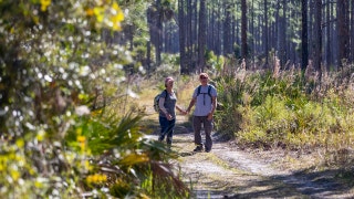 Parents of deceased fugitive Laundrie resurface in park where remains found
